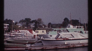 1967: a view of some small moored boats at a pier on a very crowded bay MONTREAL