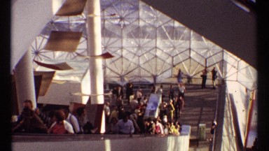 1967: a large group of people filling up an escalator in a modern and industrial