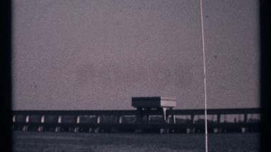 1967: water and bridge also above the water and a heavy object also there and