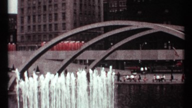 1967: lot of people enjoying the cool atmosphere of a park with fountains,