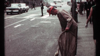 1967: sanitation worker sweeps trash on busy city street TORONTO CANADA