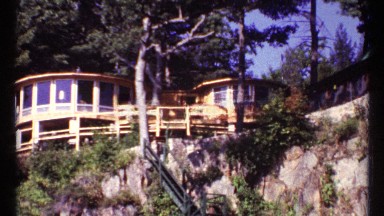 1967: view of a big beautiful house overlooking the side of a cliff side.