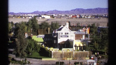 1972: view of large home from a hillside with people on the lawn ARIZONA
