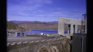 1972: a place that has a water dam and bridge and a sitting chair at long