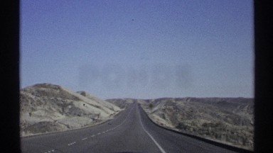 1972: a jeep travelled at a long road and move fast it looks like highway but