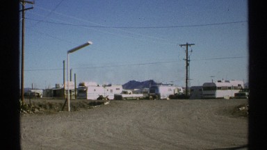 1972: parked campers at a flat site allow for picturesque view of mountain