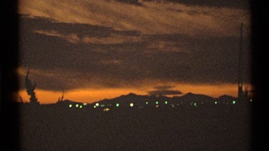 1972: a beautiful view of a city from a far distance .rays from the sun making