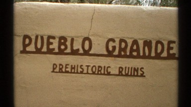 1972: a sign showing pueblo grande prehistoric ruins filmed by a handheld camera