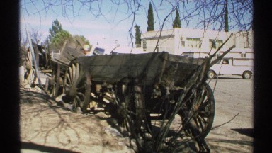 1972: man walks between two wooden wagons on side of road after accident ARIZONA