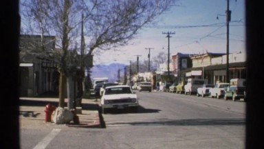 1972: An American Street Scene with Cars Parked Alongside the Sidewalk and Pedestrians