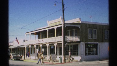 1972: a building that looks like apartments and some people are walking there