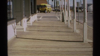 1972: a road yellow colour bus is standing and people is walking near by bus
