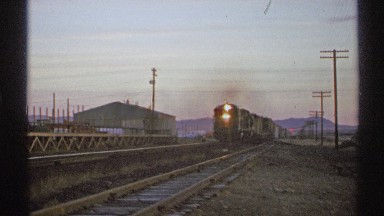 1972: train driving on a track at dusk ARIZONA