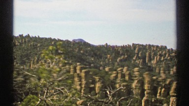 1972: in the desert going up a hill with rock formations that look like pillars