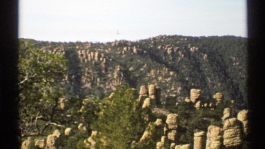 1972: a view of a mountain side with rock formation in the front. ARIZONA