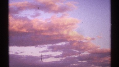 1972: clouds at dusk appear orange and purple against patches of blue sky NEW
