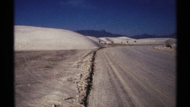 1972: a deserted area with hills and objects blowing in the wind. NEW MEXICO