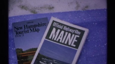 1971: a pile of tourism brochures for states sit on a table NEW YORK