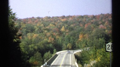 1971: an elevated stretch of highway winds through the woods. NEW YORK