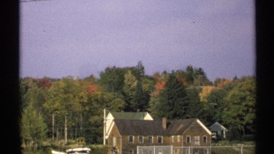 1971: two views of a small residential area with wooded areas with buildings and