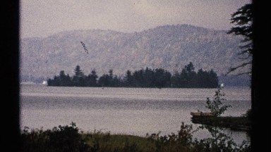 1971: a normal nature look that contain water, trees, and mountain also looking