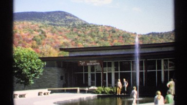 1971: a place of swimming pool and people are standing closed nut it under the