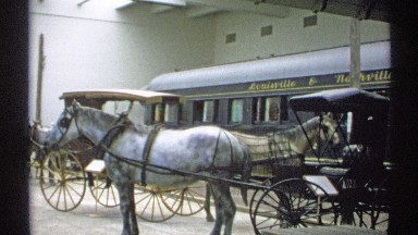 1971: two prepared horse drawn carriages wait in front of a bus NEW YORK