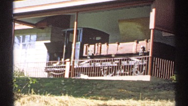 1971: an old fashioned train car sits on display on a porch NEW YORK