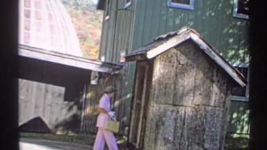 1971: Old Lady in Pants and Gloves Entering Shed and Changing Her Mind