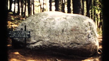 1971: shiny day inside a park a big rock with a title is placed inside the park