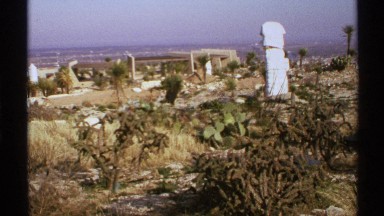 1972: Headless and Cracked Figure Surrounded by Neglected Garden in New Mexico
