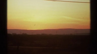 1972: sunset view of the highway roads with the sun sinking behind the