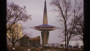 1972: a tall, pointy structure with a saucer on it sits in the distance. TULSA