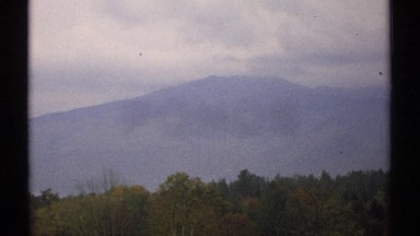 1971: three layer scenery that includes trees, mountains, and the sky NEW