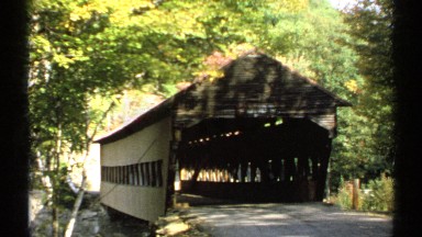 1971: old wooden covered bridge with road going through in the woods. NEW