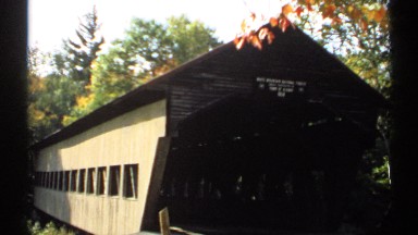 1971: a building that looks like parking area or a storage place with roof top