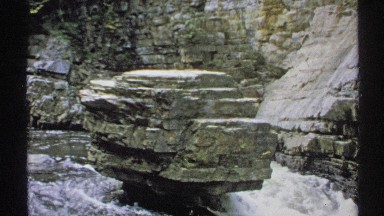 1971: magnificent view of river flowing around the shaped stone in the water NEW