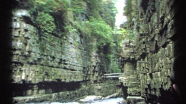 1971: a person is slowly making his way down a narrow waterway surrounded by