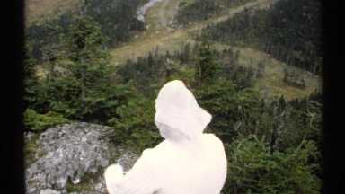 1971: lady in white taking in the view from a mountain top VERMONT