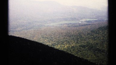 1971: a view of hills full of greenery and water pond , cover with forest and