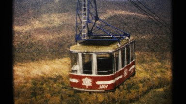 1971: elevated cabin suspended from cables ascends mountain toward tower VERMONT