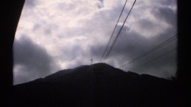 1971: ominous clouds hang over a mountain as the sun struggles to break through