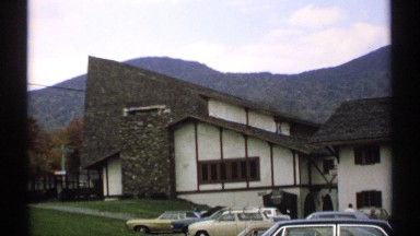 1971: a hunt or house located at very calm place and a mountain background of