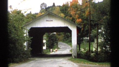 1971: three children merrily skipping toward wooden covered bridge VERMONT