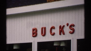 1971: large white building with red letters spelling out the business name.