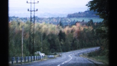 1971: driving down a country road, blue skies and trees around VERMONT