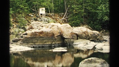 1971: this is a hill that leads to a large rock formation that is surrounded by