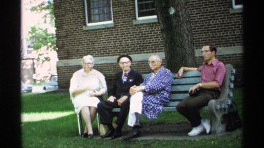 1971: three older people and a younger man sit on a park bench WISCONSIN