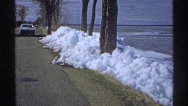 1970: there is a car near the grass outside in the winter weather near the water
