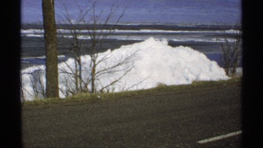 1970: a ocean and some far away a snow mountain also there and trees also